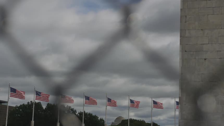 American flags flutter in a stiff breeze on a cloudy day