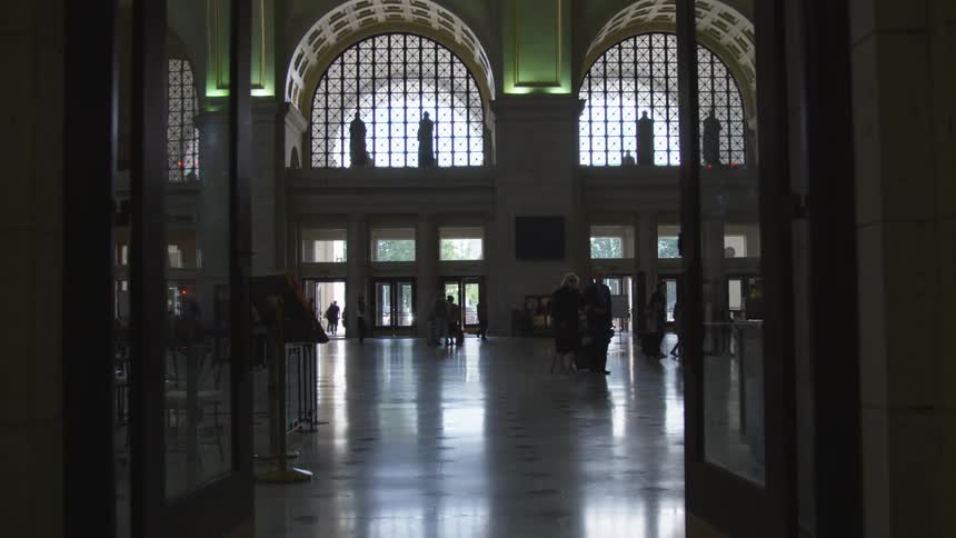 People walk through foyer in office building