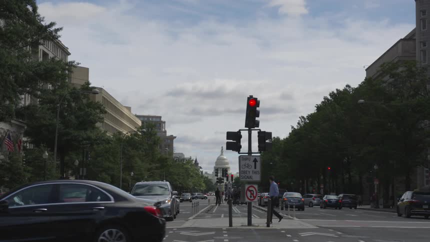 Cars travel through traffic light controlled intersection