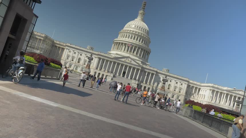 People walking near a capital building