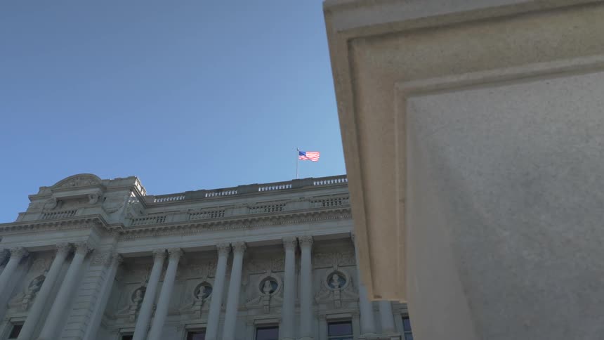 A large building with a flag on the top of it