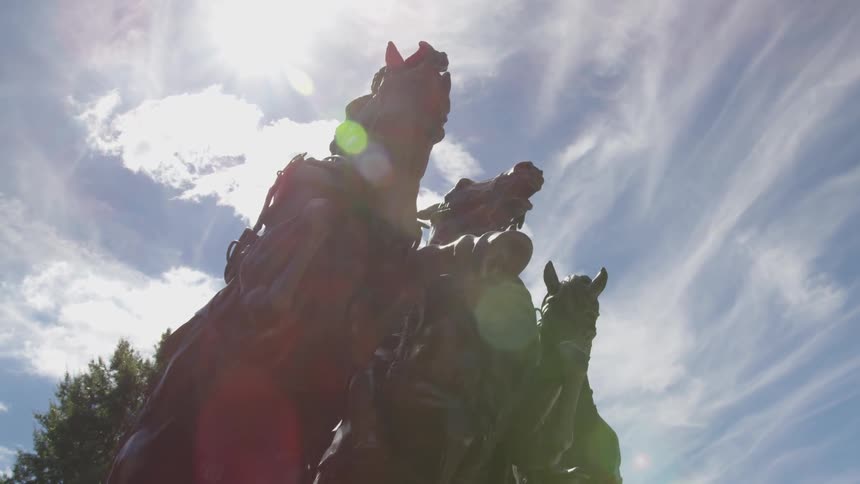 Worms eye view of a statue of three horses