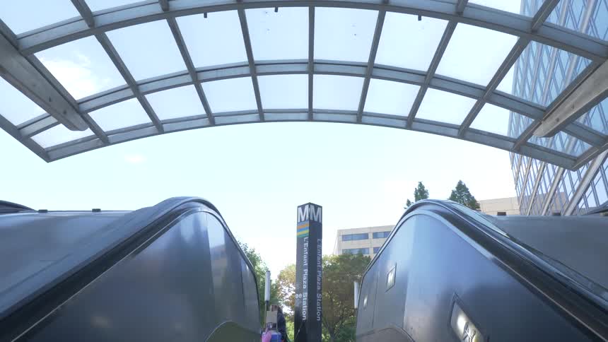An escalator moving up the building