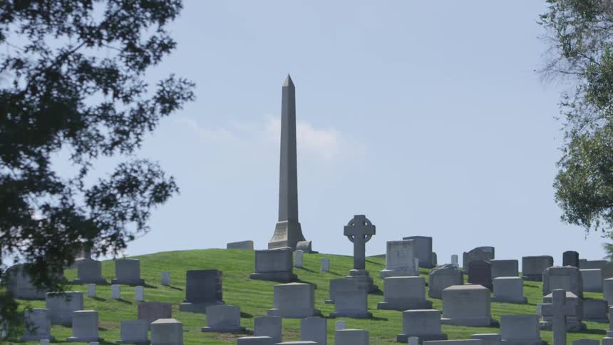 A large monument in the center of a cemetery