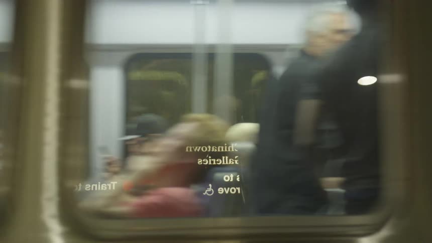 Subway train filled with people leaves the subway tunnel