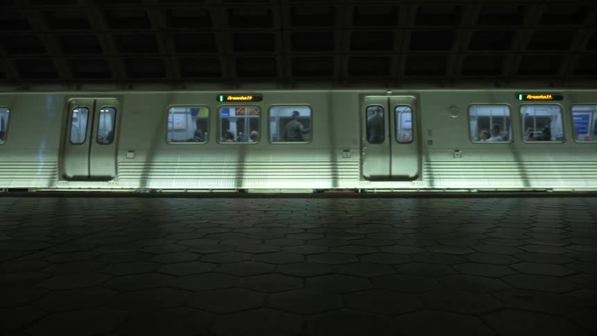 Subway cars filled with passengers slide to the left