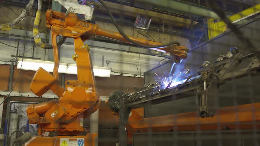 A robot welding a piece of metal in a factory