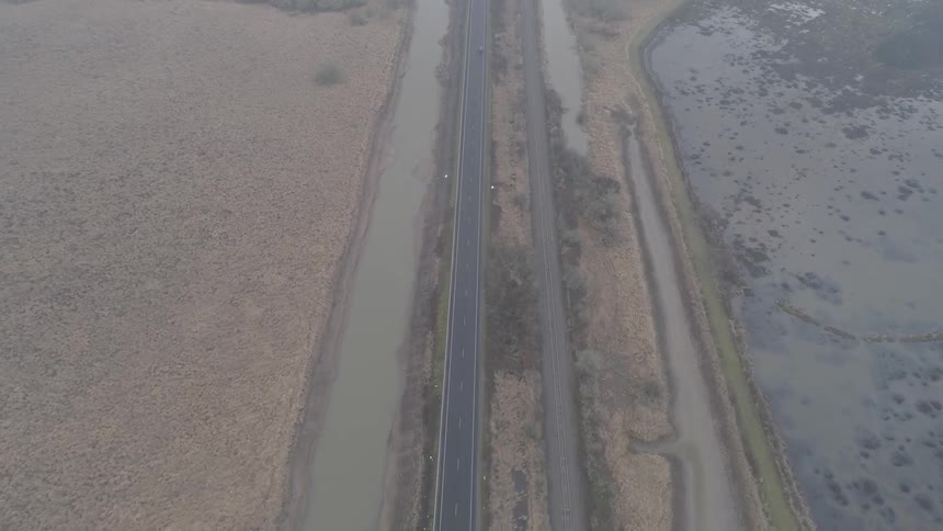 Road and water filled ditches parallel each other