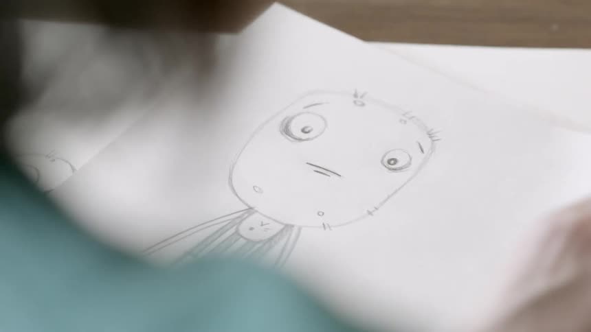 Cartoonist checks their drawing by flipping a page
