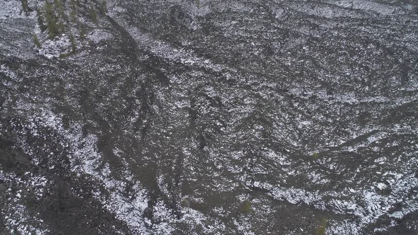 Dark snowy terrain sits peacefully amongst the land