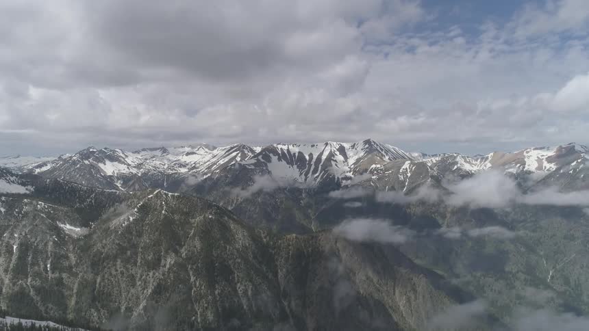Clouds pass over mountain range and forest