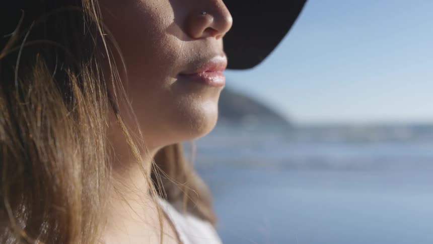 A woman is outdoors at a beach