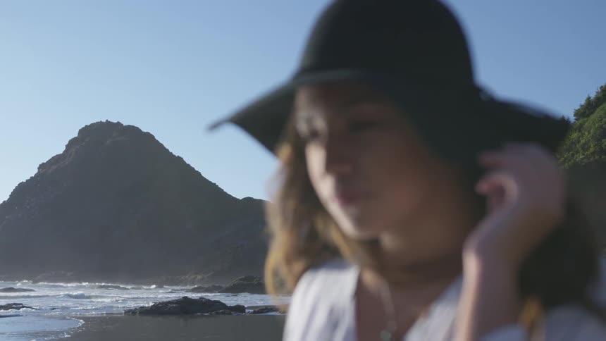 An out of focus woman in front of a cliff