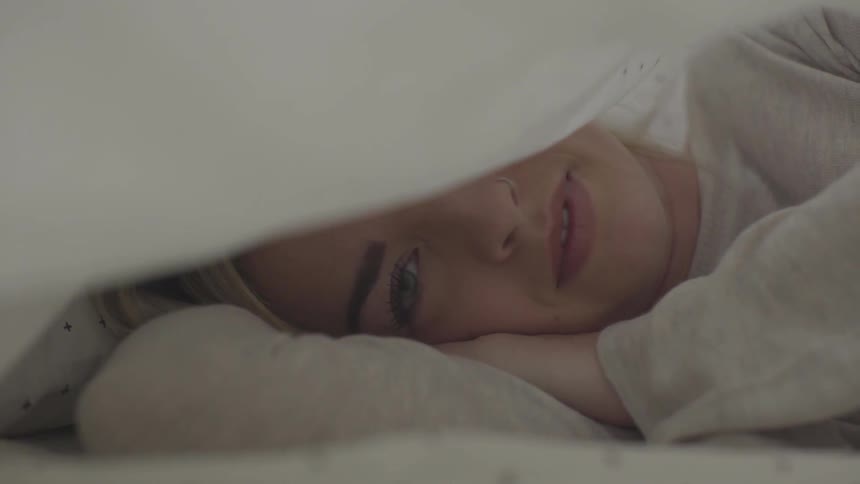 A woman laying on a bed