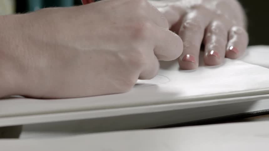Artist drawing in a book