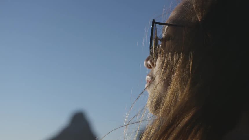 A woman is wearing sunglasses outdoors