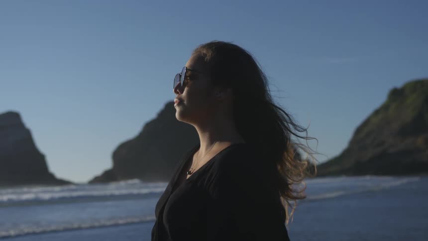 Woman standing next to the water