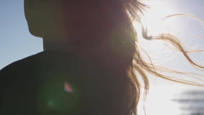 A womans hair blows in the wind