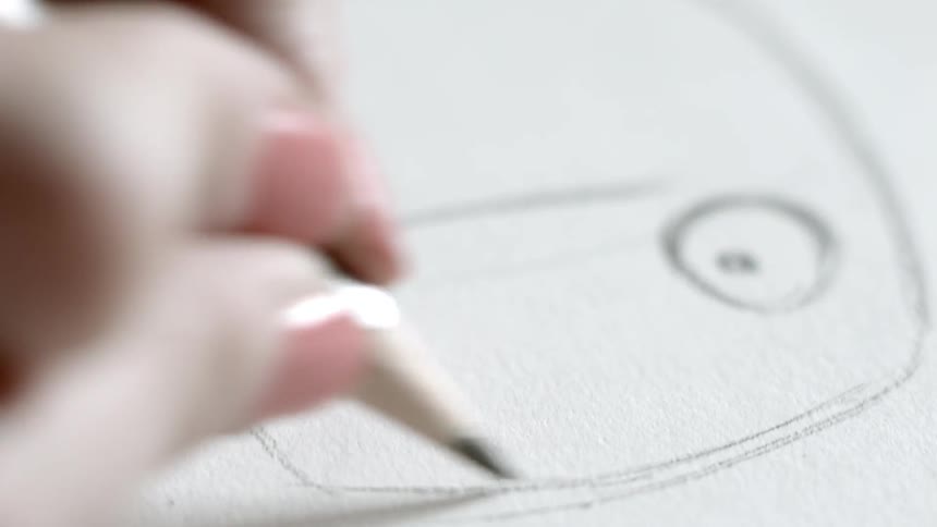 Fingers and hand sketching a cartoon face