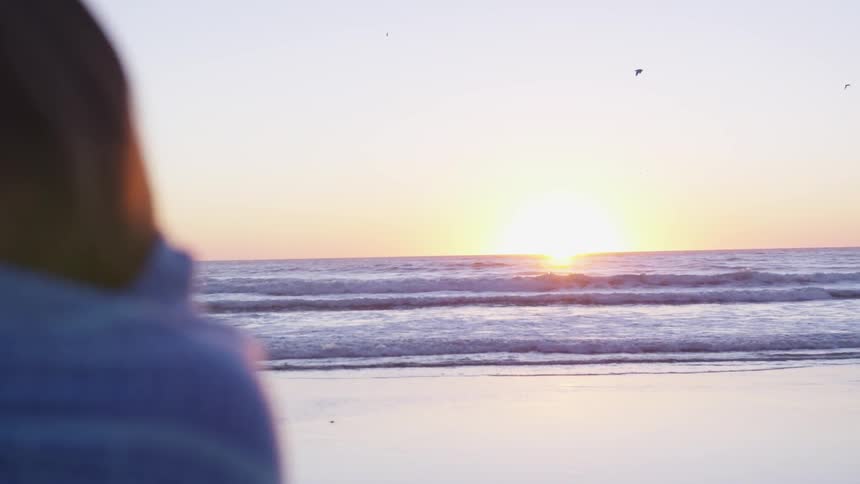 Woman standing next to the ocean