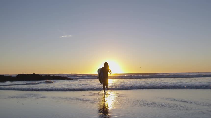 A woman is running to the beach