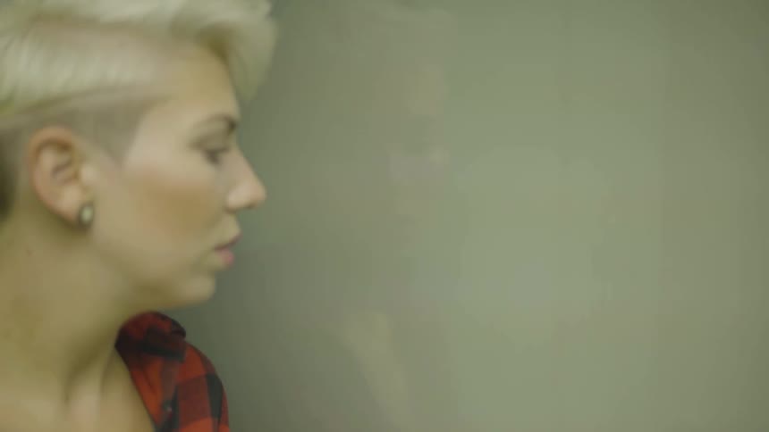 A woman is in an elevator indoors