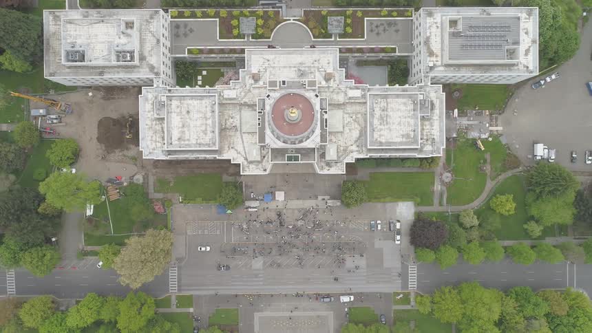 Birds eye view of a building and the surrounding green space