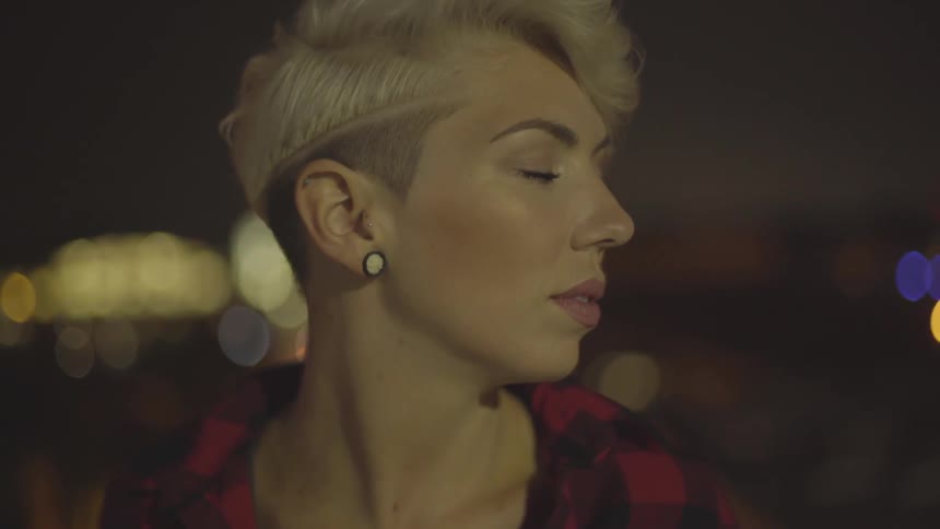 A woman has her eyes closed in the evening