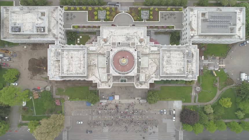 An aerial view where people are outside a building