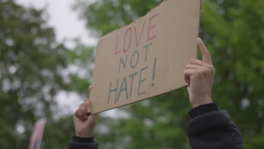 A man holds a sign of protest