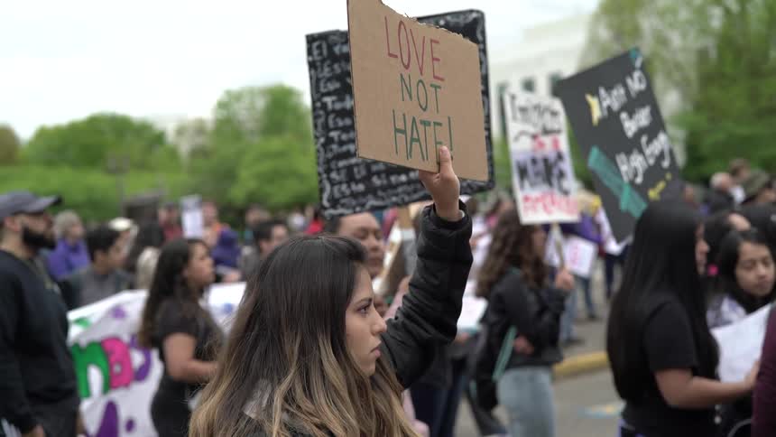 Woman holding a sign on the streets at a protest
