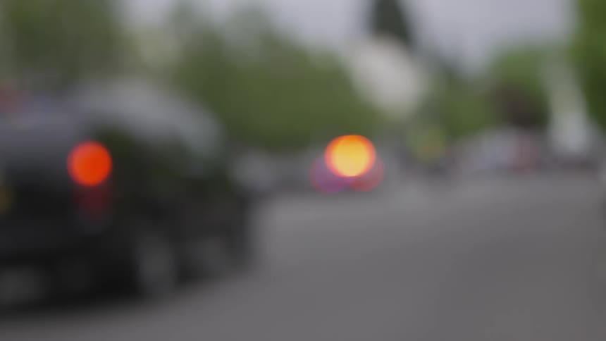 Lights on police vehicles flash while parked on the street