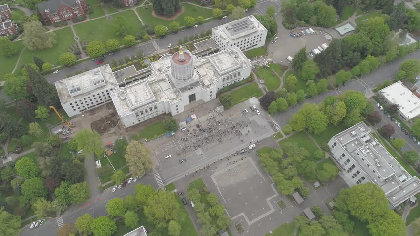 An aerial shot of a building and a park