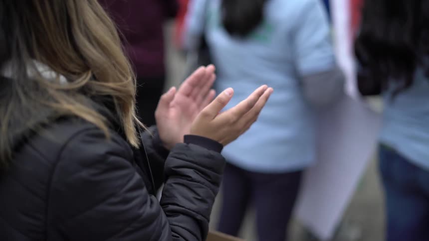 People are clapping in a crowd
