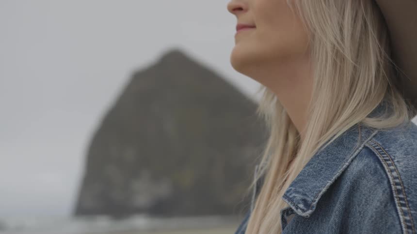 A woman is outdoors smiling