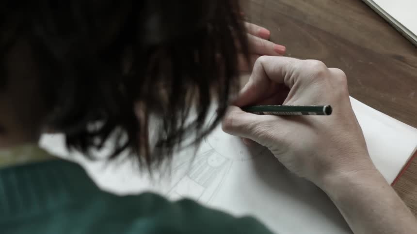 A person is drawing a cartoon
