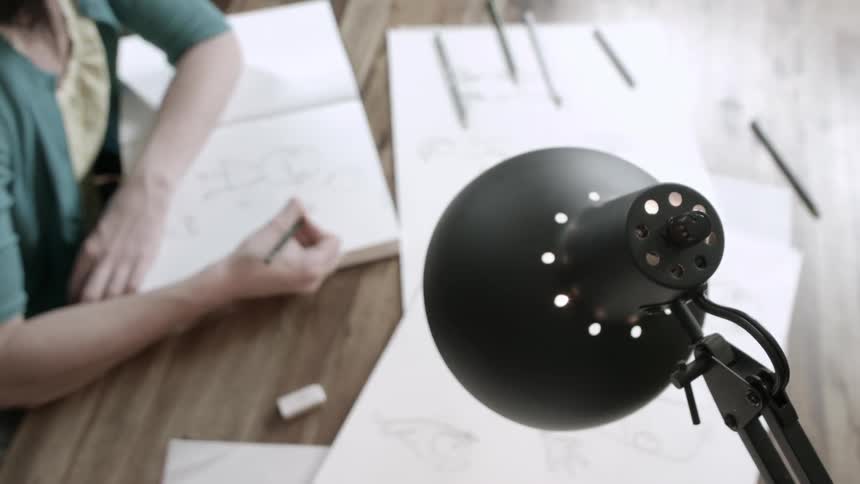 A woman is drawing a cartoon