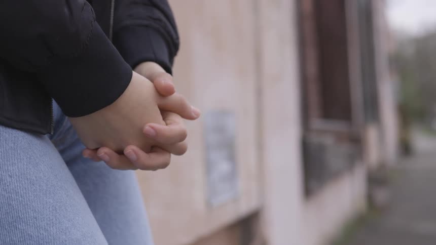 Person placing hands down near legs