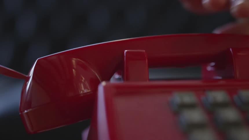 Red phone receiver is placed back into its cradle