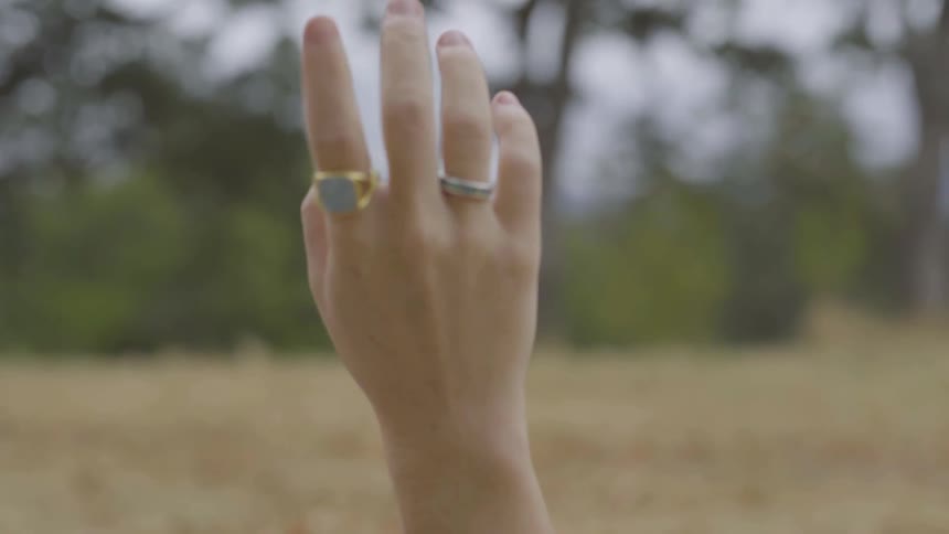 A woman is reaching her arm up