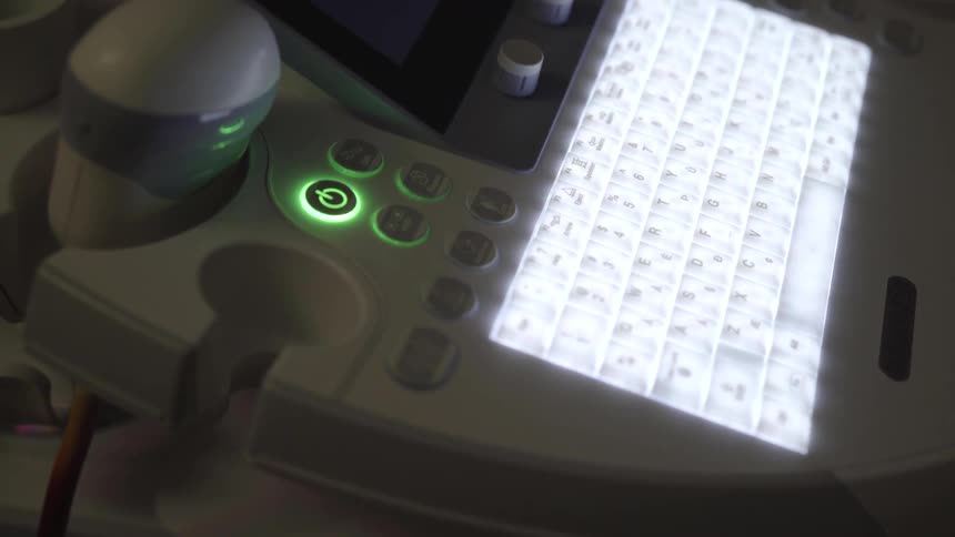 A computer with a backlit keyboard in a dark room