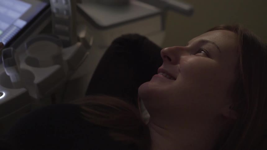 A woman lies in a examining chair