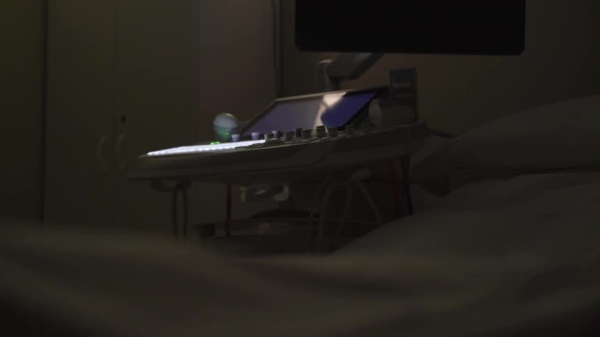 A strange computer sits on a surface in the dark