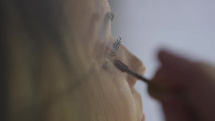 Woman applies makeup