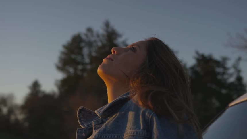 A woman looks up towards the sky