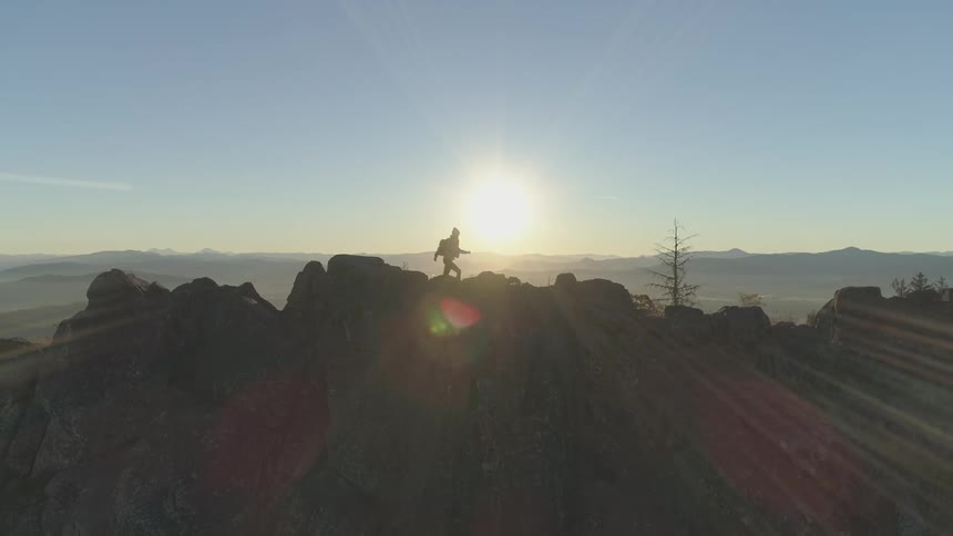 A woman hikes across a rocky area