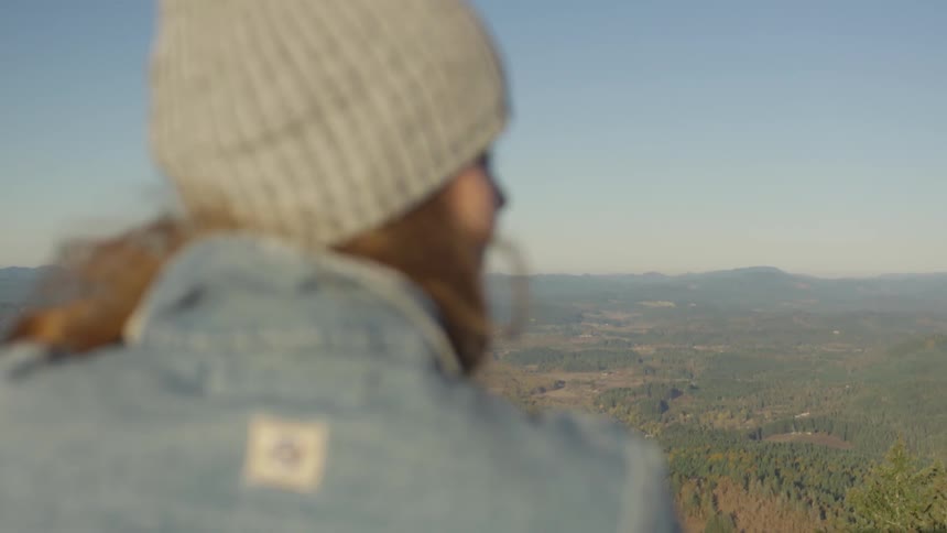 A woman is looking at the horizon