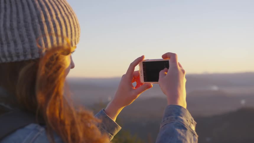 Woman takes a picture with a smartphone