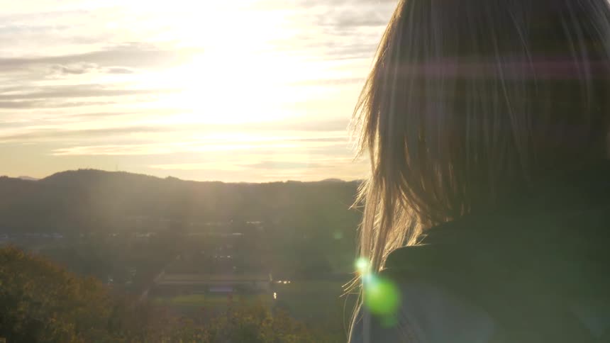 A woman watches into the hillside