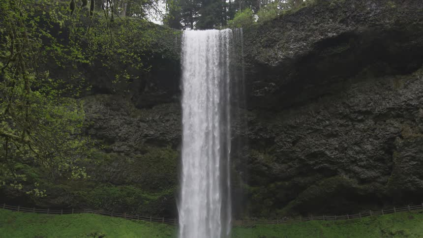 Water is falling from a waterfall outdoors